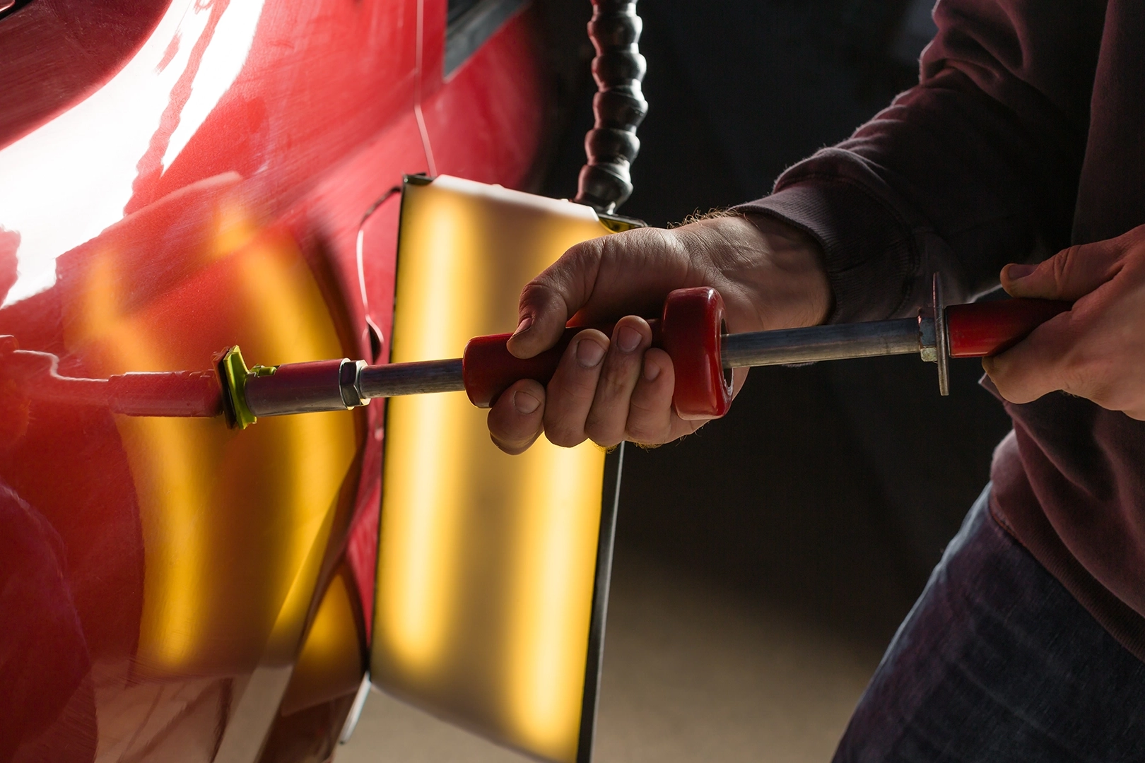 Car Dent removal tool pulling a dent out