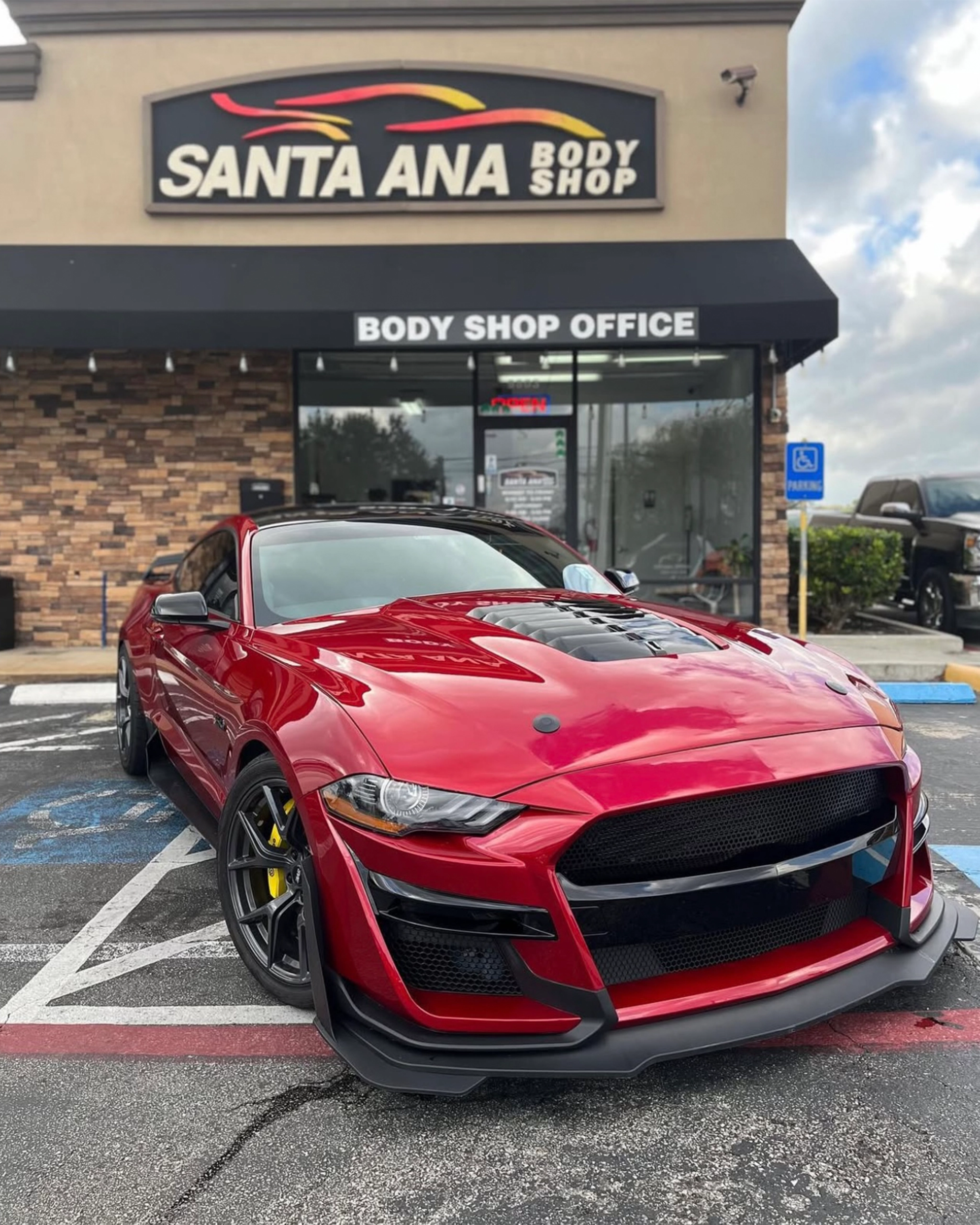 Sports car parked outside santa ana body shop